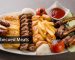 persian mix grill platter with tikka boti, lamb chop, meat kabab, fish, fries and tomato sauce served in dish isolated on grey background top view of arabic food